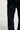 Nahaufnahme einer Person, die eine 2Y Studios Men Firio Destroyed Straight Jeans Black trägt, die auf der Vorderseite mehrere zerschlissene und zerrissene Flecken aufweist.