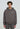 Eine Person steht vor der Kamera in einem verwaschenen grauen LowLights Basic Zip Hoodie von LowLights Men, gepaart mit einer passenden Hose, beide mit der Aufschrift "lowforher".