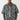 Ein Mann steht mit dem Gesicht nach vorne und trägt ein True Religion Super T Oversize Jacquard Shirt Dark Wash mit passender Hose in grauem und schwarzem Camouflage-Muster.