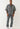 Ein Mann trägt das True Religion Super T Oversize Jacquard Shirt in Dark Wash mit einem grauen und schwarzen abstrakten Muster vor einem schlichten weißen Hintergrund.